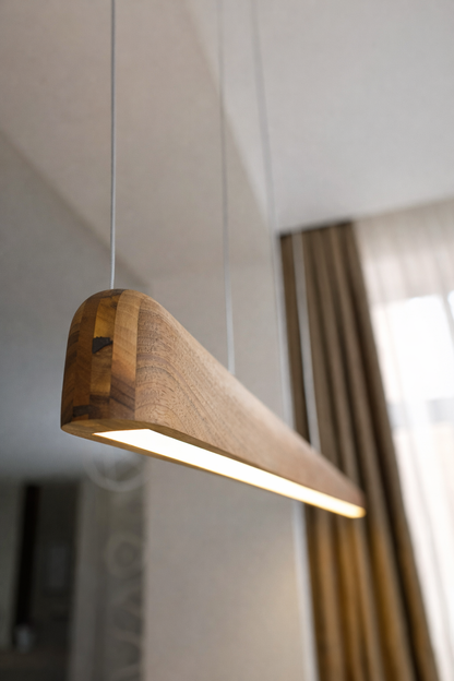 modern wooden LED pendant lamp hanging over dining table